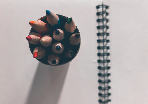 Notebook and pencils, objects on the table
