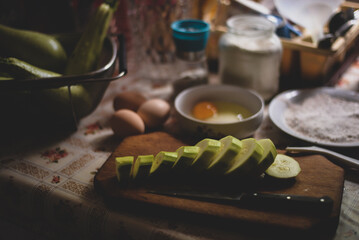 sliced zucchini on a vintage chopping board in the kitchen 