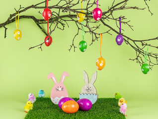 Easter tree, wooden bunny, and colored eggs. Holiday composition.