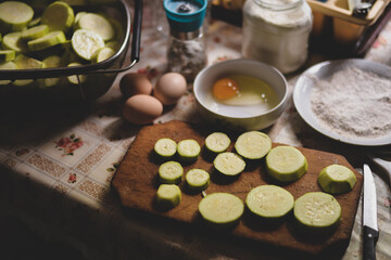 sliced zucchini on a vintage chopping board in the kitchen 