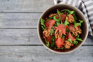 Arugula salad with grapefruit, walnut and pomegranate seeds