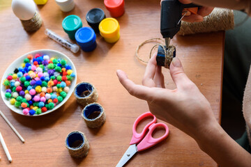 The girl's hands make crafts with a rut pistol