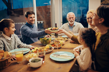 Fototapeta na wymiar Happy extended family having dinner at dining table at home.
