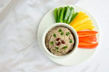 Adzuki bean dip, garnish with sesame seeds and parsley. Served with red, yellow and green bell...