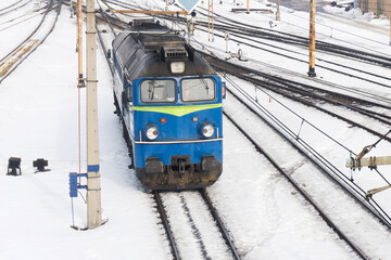 Cargo train background. Winter transportation background. Railway top view. Snowy train tracks. Locomotive waiting for cargo. Transportation in Poland.