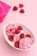 Scoops of raspberry ice cream in a bowl. Summer dessert