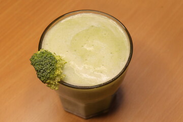 Fresh healthy broccoli Juice isolated on wood background