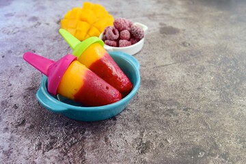 Fresh mango raspberry popsicles. Summer dessert