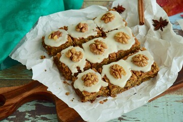 Gluten free carrot quinoa square cake bites topped with sugar glaze and walnut