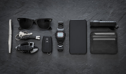 Set of EDC (Every Day Carry) items on dark background