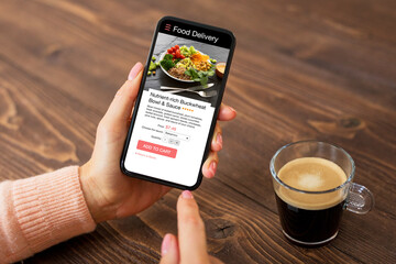 Woman ordering meal online using app of food delivery service