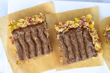 Chocolate avocado tart with pistachio date almond cranberry crust