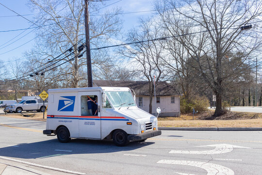 Buford, Georgia - Jan 20th 2021: United States Postal Service Van Delivering Mail In Buford, Georgia