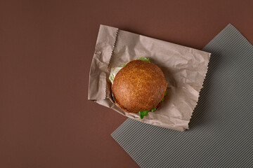 Vegan ceviche burger with vegetables on the paper bag. Copy space. Vegetarian food concept. Top view