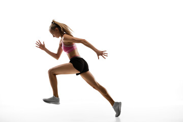 In air. Caucasian professional female athlete, runner training isolated on white studio background. Muscular, sportive woman. Concept of action, motion, youth, healthy lifestyle. Copyspace for ad.