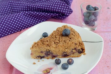 Slice of blueberry crumble cheesecake. Dessert for coffee time