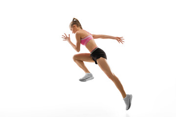 Fototapeta na wymiar In jump. Caucasian professional female athlete, runner training isolated on white studio background. Muscular, sportive woman. Concept of action, motion, youth, healthy lifestyle. Copyspace for ad.