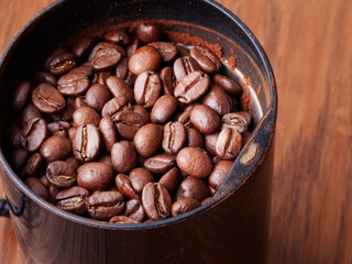 Macro photo of freshly ground coffee in electric coffee grinder.