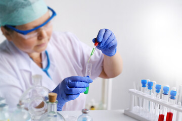 Fototapeta premium female scientist, laboratory assistant, researches a DNA test in the laboratory, researches a vaccine against COVID-19, creates a new drug, a concept of innovation in modern science