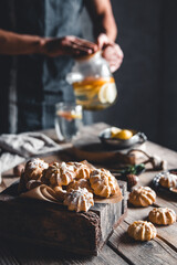 Man pours Hot tea with slices of fresh grapefruit on wooden tablet. Healthy drink, Eco, vegan.