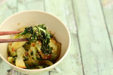 Cooked pak choi with soy sauce and sesame seeds 