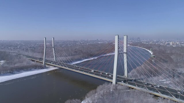 Siekierkowski Bridge on the Vistula River in Warsaw during a winter and sunny day.