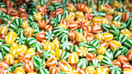 Striped multicolored candies in a box. Junk sweet food. Sweet tooth paradise. Junk food for kids