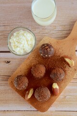Healthy organic brazil nut coconut chocolate energy balls served with milk