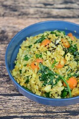 Organic Paleo Cauliflower Fried Rice with vegetables, Herbs and Spices. On wooden background