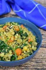 Organic Paleo Cauliflower Fried Rice with vegetables, Herbs and Spices. On wooden background