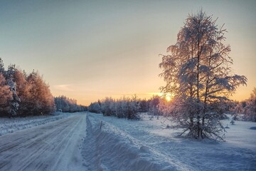 HDR shot of winter sunrise and icy road in Swedish Lapland