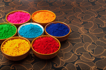Holi color powder. Organic Gulal colors in bowl for Holi festival, Hindu tradition festival. Bright vibrant Holi