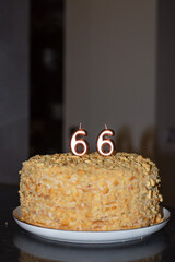 Festive cake with golden candles - number 66.