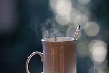 Tall white cup with highlights on a blurred background