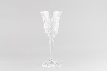 Crystal wine glass on gray background