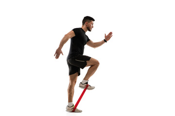 Stretching. Caucasian professional sportsman training isolated on white studio background. Muscular, sportive man practicing. Copyspace. Concept of action, motion, youth, healthy lifestyle.