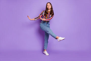 Full length body size photo of cheerful happy woman dancing at party on weekends isolated on vivid violet color background