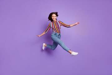 Fototapeta na wymiar Full length body size photo of pretty girl jumping up childish playful smiling isolated on bright purple color background