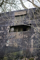 A brutalist cold gritty concrete world war two, ww2, pillbox war bunker defence fortress in a dirty...