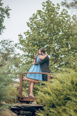 Fototapeta premium Woman and man hugging on bridge