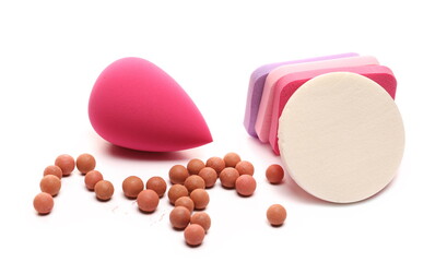 Beauty blender set and blusher balls pile, cosmetic makeup applicator sponges with makeup powder isolated on white background
