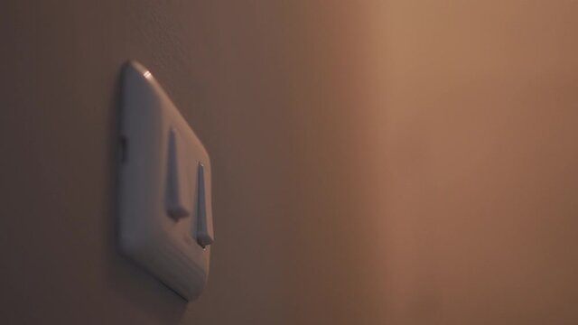 4K Close up hand push switch on-off electric light. Concept of energy and power saving.