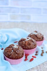 Chocolate muffins with coconut flakes, goji berry and chocolate chips