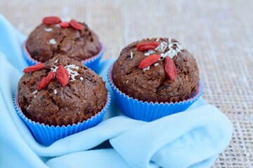 Chocolate muffins with coconut flakes, goji berry and chocolate chips