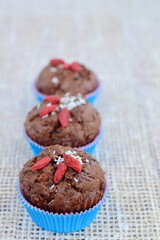 Chocolate muffins with coconut flakes, goji berry and chocolate chips