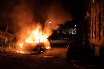 Belgrade, Serbia, 08.07.2020 Burning police car in the center of city near church during riots caused by new measures of coronavirus. © Dragan