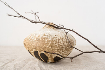 Handmade ceramics in the style of wabi sabi. Brown clay vase with an abstract pattern.