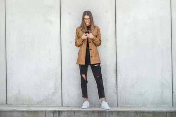 Young girl in glasses speaks by smartphone. 