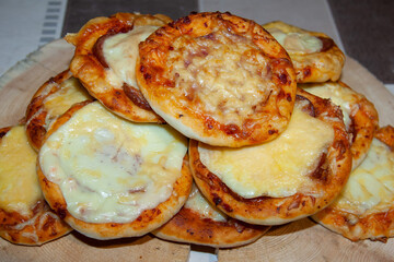 There are small pizzas on the table.