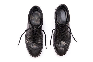 Dirty dusty black shoes with dirty stains after rain isolated on white